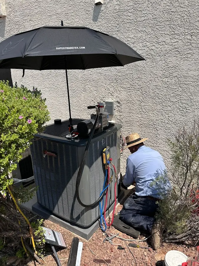 HVAC technician performing outdoor AC maintenance in Columbia City